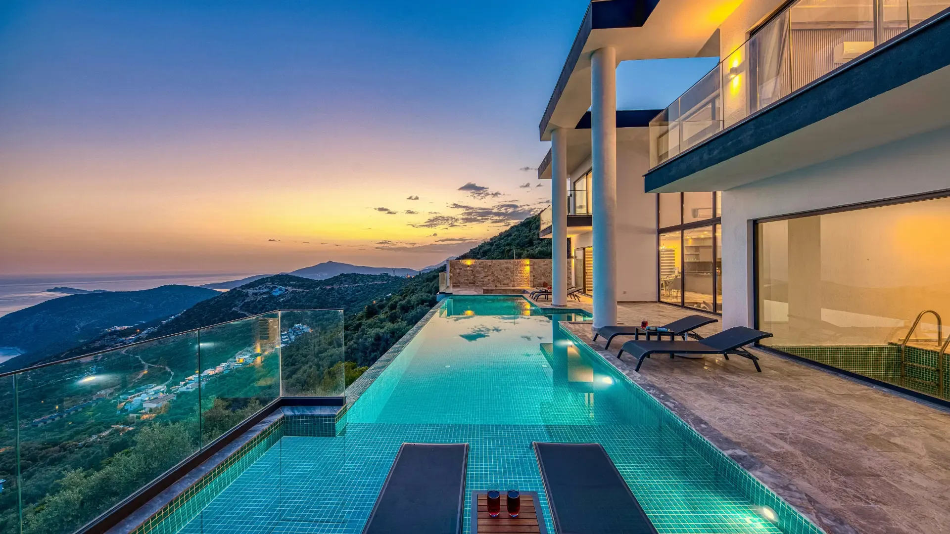 Contemporary villa with an infinity pool overlooking the coast at dusk on the Costa del Sol
