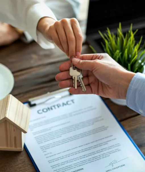 House keys handed over above a signed property contract